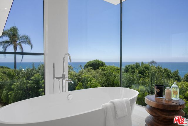 a view of a lobby with a piano and wooden floor