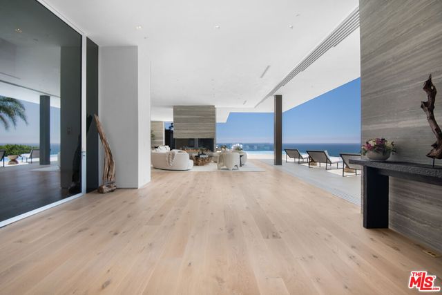 a living room with lots of furniture and kitchen view