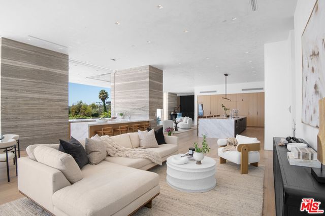 a living room with furniture kitchen view and a fireplace