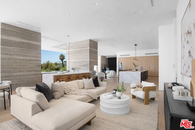a living room with furniture kitchen view and a fireplace
