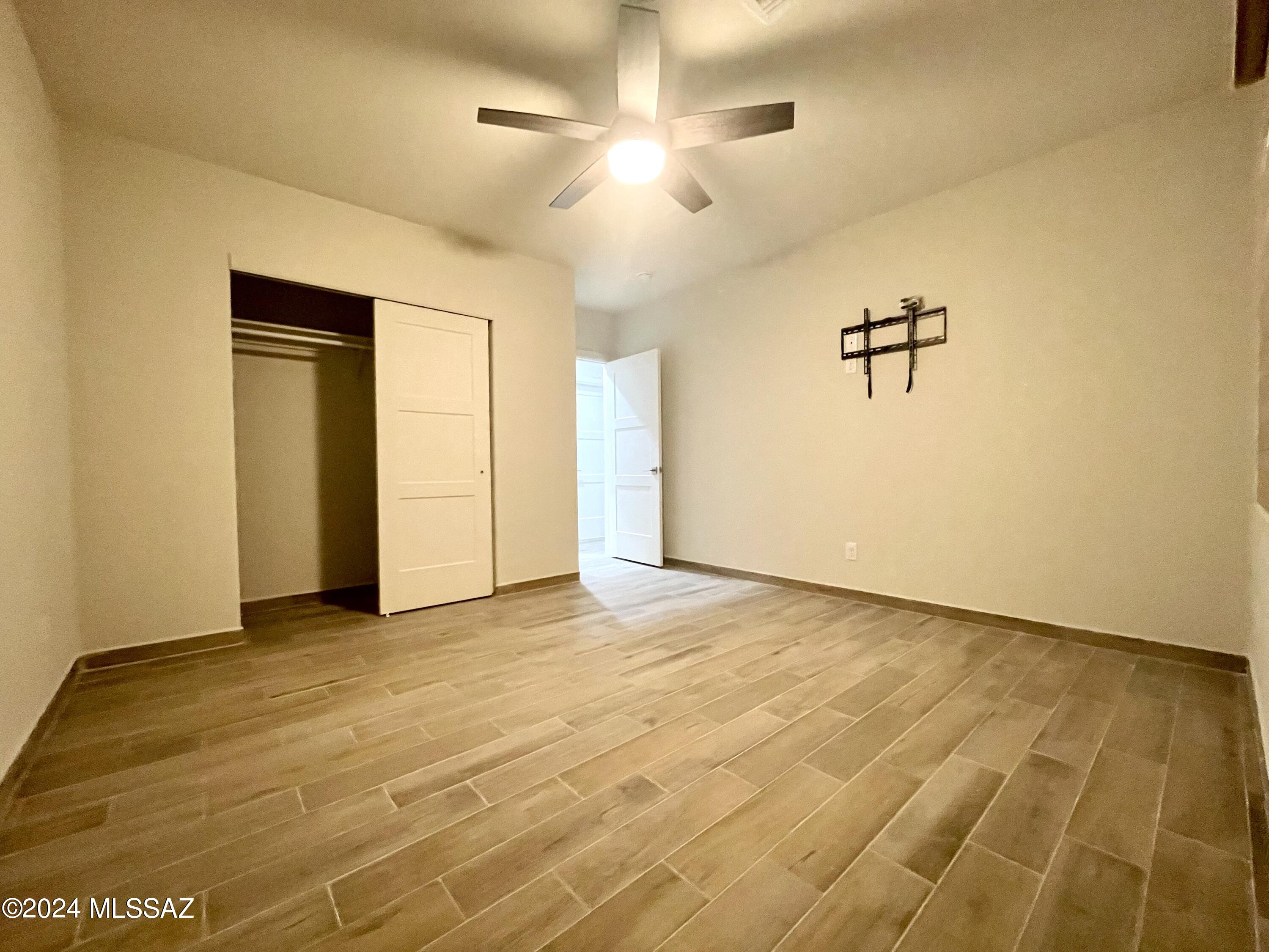 1049 Camino Estrella Rio Rico, AZ 85648 - Photo 23 of 28 wooden floor in an empty room