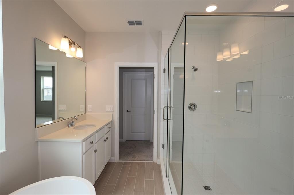 5276 Ctr Lk Rnch Boulevard St. Cloud, FL 34771 - Photo 17 of 23 a bathroom with a double vanity sink toilet mirror and shower