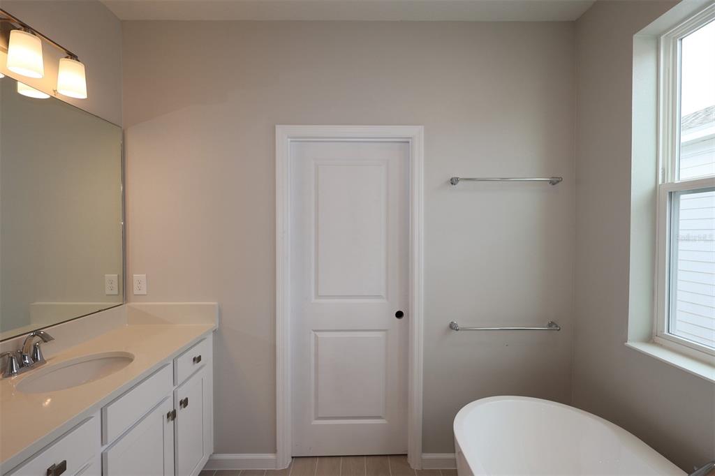 5276 Ctr Lk Rnch Boulevard St. Cloud, FL 34771 - Photo 18 of 23 a bathroom with a sink a toilet and window