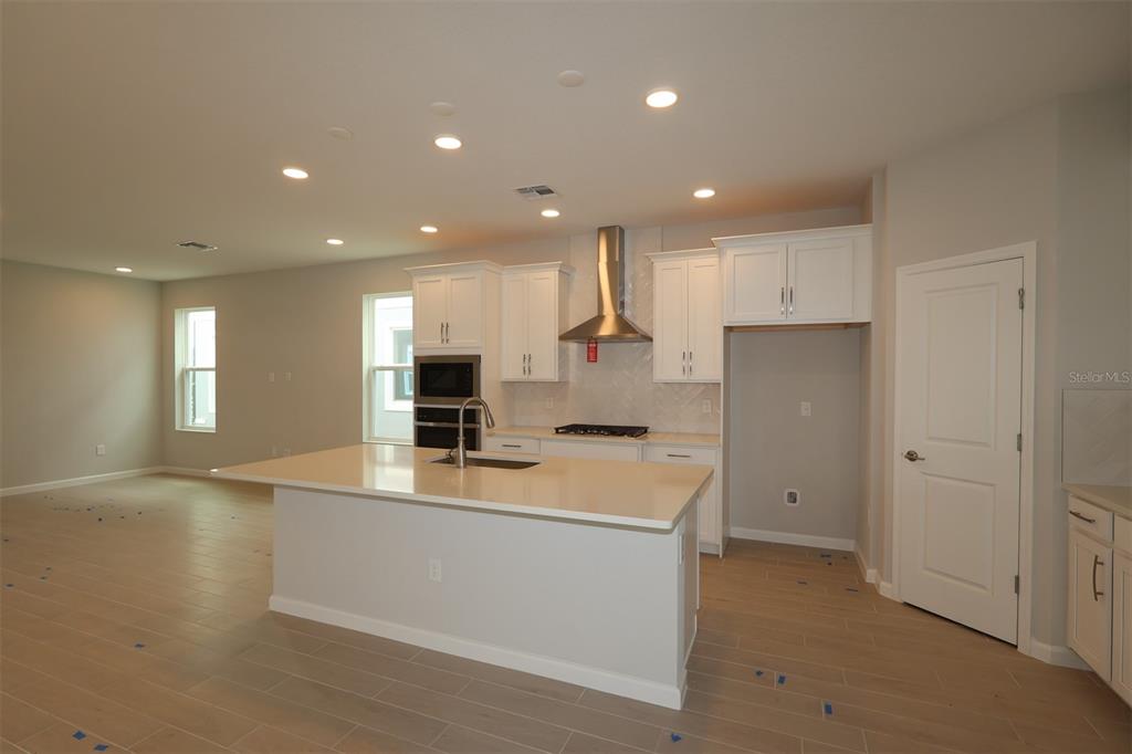 5276 Ctr Lk Rnch Boulevard St. Cloud, FL 34771 - Photo 3 of 23 a view of kitchen with refrigerator sink and wooden floor