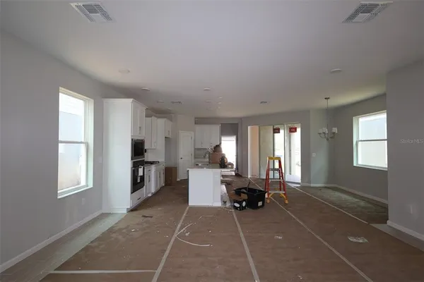 a living room with furniture a large window and a table