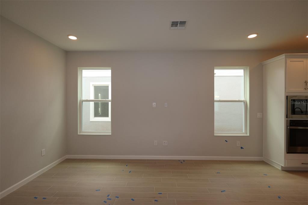 5276 Ctr Lk Rnch Boulevard St. Cloud, FL 34771 - Photo 7 of 23 an empty room with a window and a mirror
