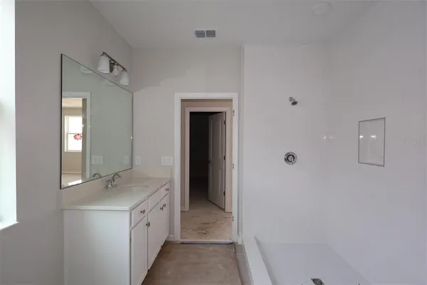 a bathroom with a double vanity sink and mirror