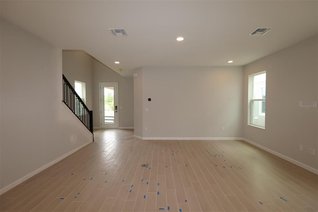 5276 Ctr Lk Rnch Boulevard St. Cloud, FL 34771 - Photo 8 of 23 a view of an empty room with wooden floor and a window