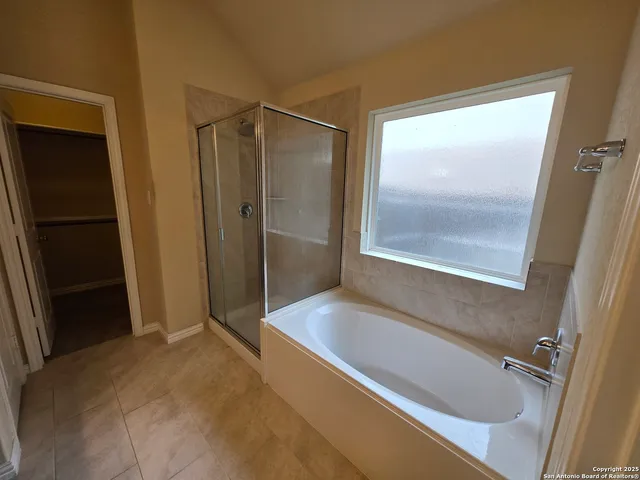a bathroom with a tub and a shower