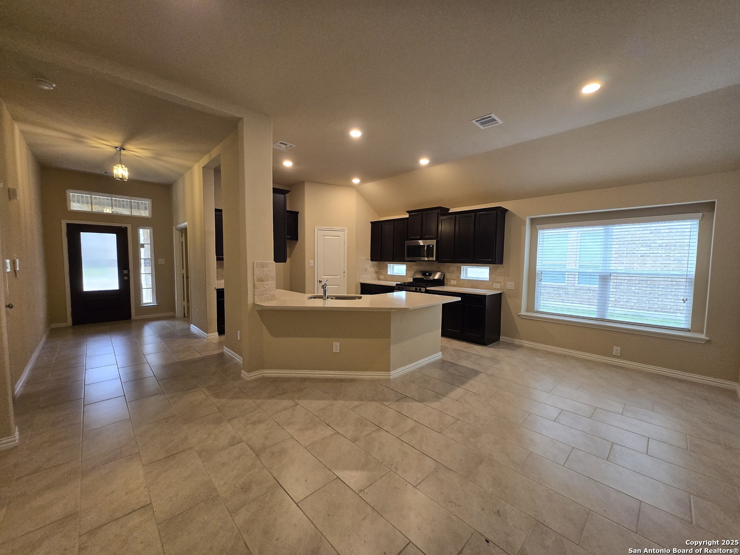 11518 Hanson's Forest Schertz, TX 78154 - Photo 5 of 26 a view of a kitchen with a sink and a microwave