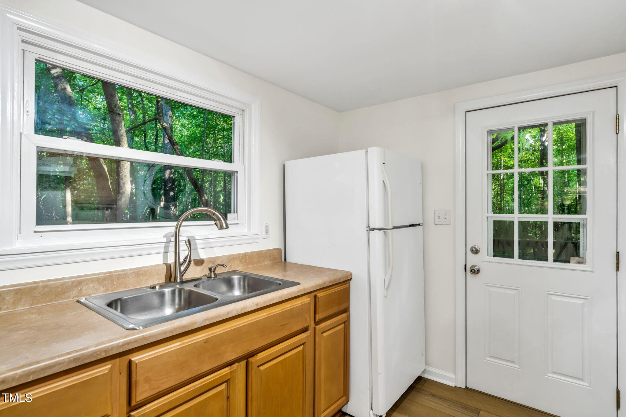 5500 Bobbitt Road Apex, NC 27539 - Photo 9 of 23 a kitchen with a sink a refrigerator and windows