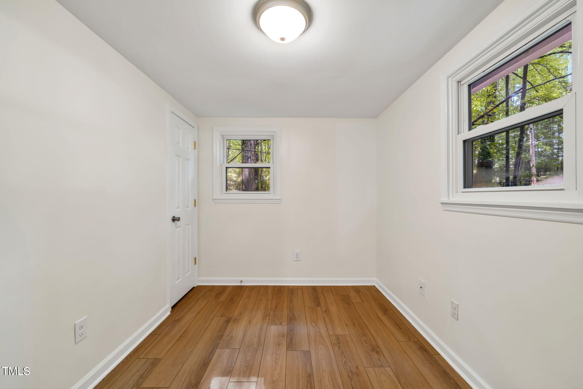 5500 Bobbitt Road Apex, NC 27539 - Photo 12 of 23 an empty room with a window and wooden floor