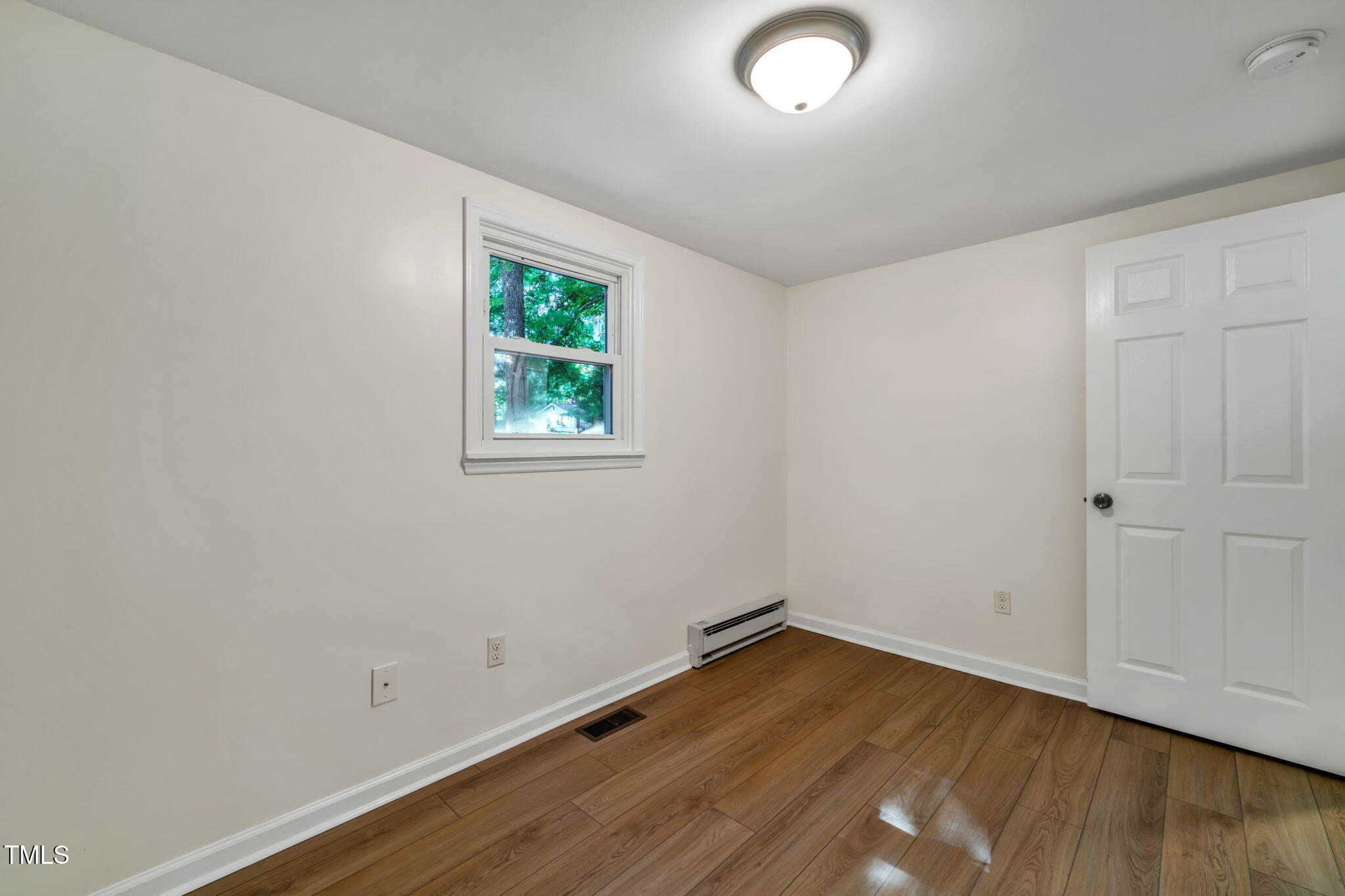 5500 Bobbitt Road Apex, NC 27539 - Photo 13 of 23 an empty room with wooden floor and window