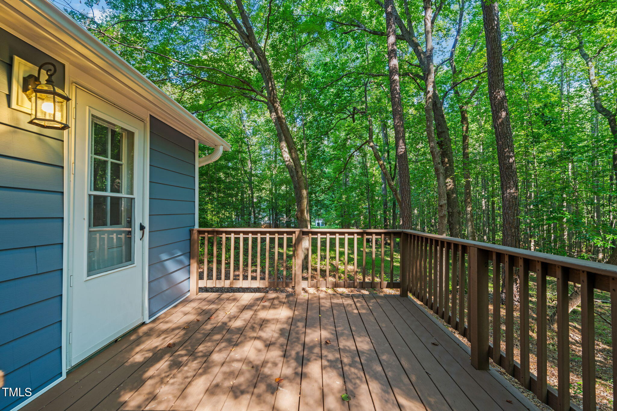 5500 Bobbitt Road Apex, NC 27539 - Photo 17 of 23 a view of backyard with deck and a garden