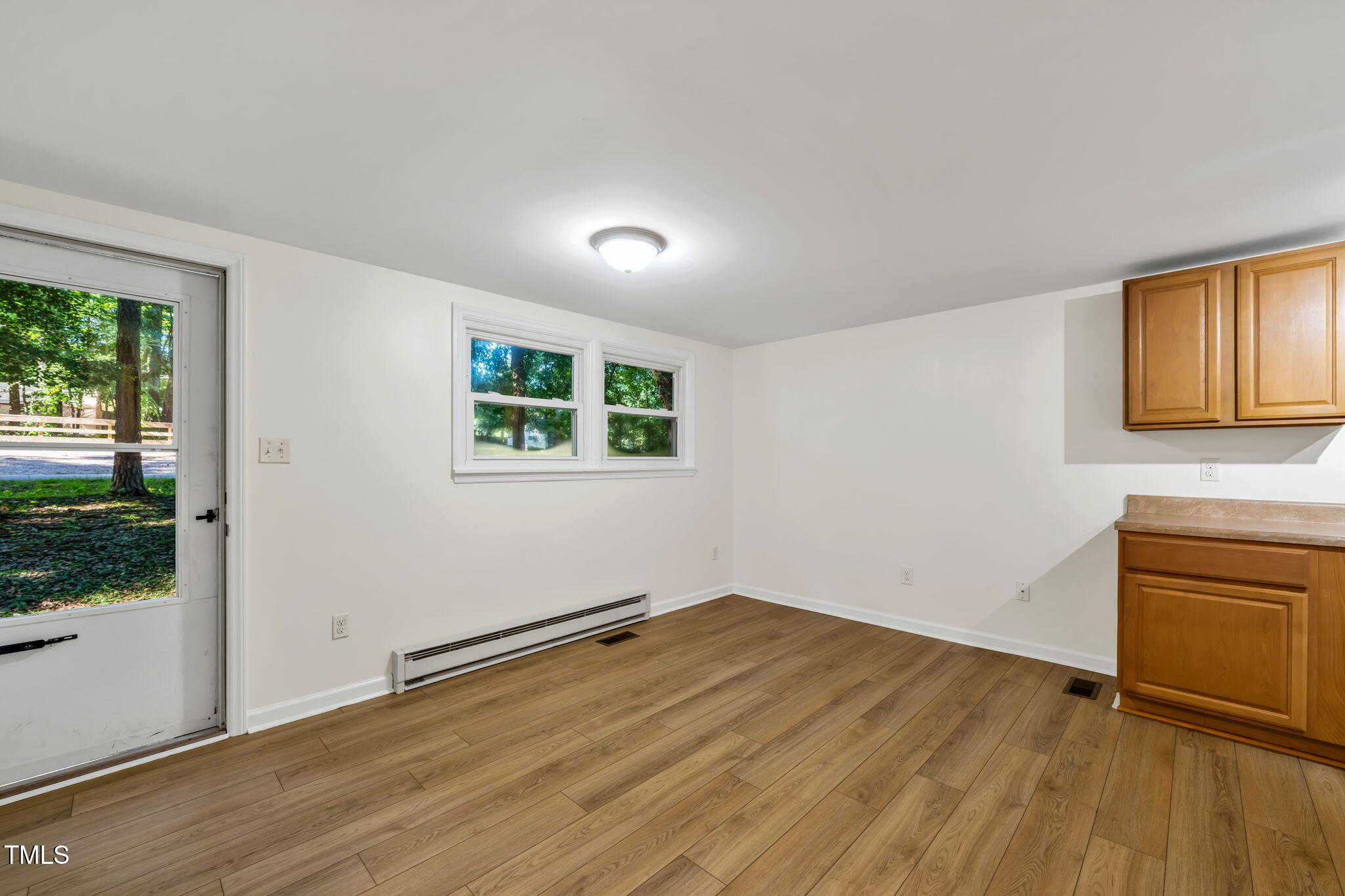5500 Bobbitt Road Apex, NC 27539 - Photo 4 of 23 a view of a livingroom with wooden floor and a window