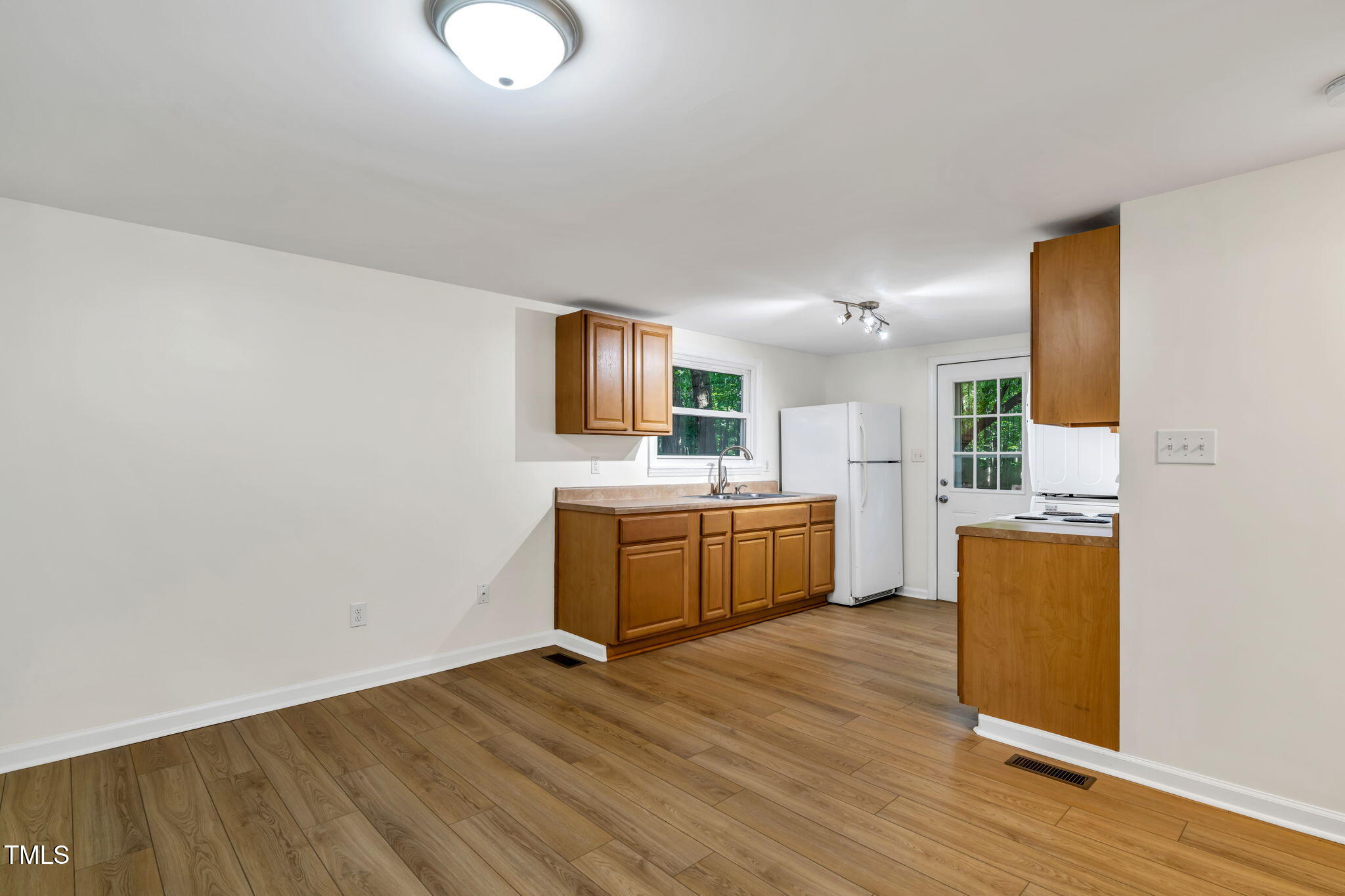 5500 Bobbitt Road Apex, NC 27539 - Photo 6 of 23 a large kitchen with a wooden floor and a sink