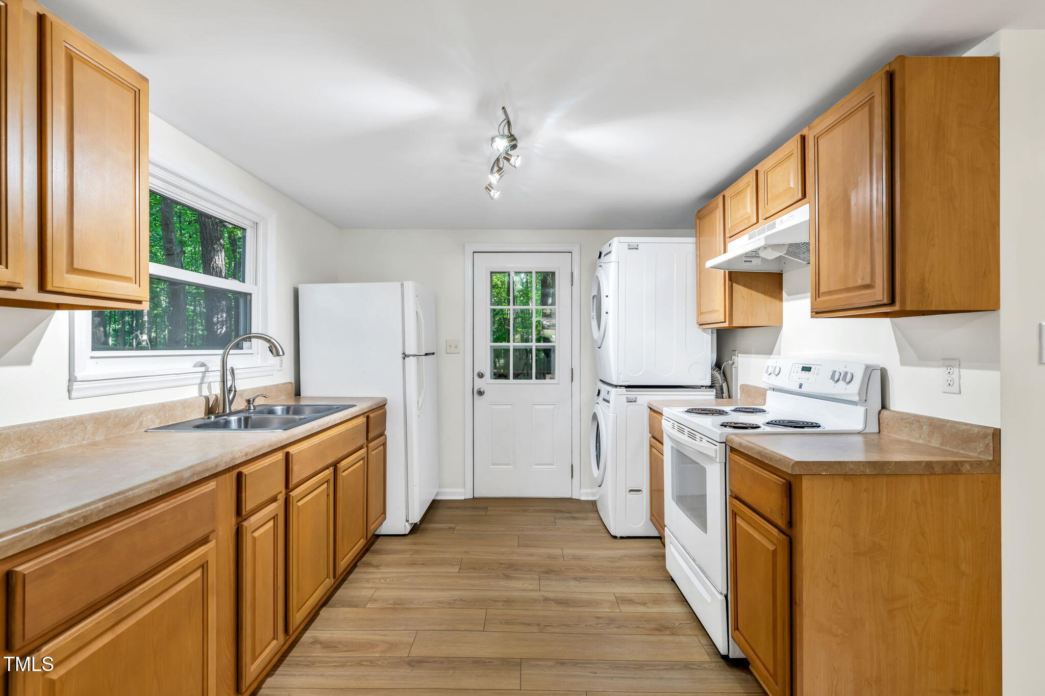5500 Bobbitt Road Apex, NC 27539 - Photo 7 of 23 a kitchen with kitchen island granite countertop a sink stove and cabinets