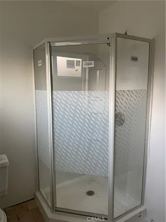 a bathroom with a glass shower door