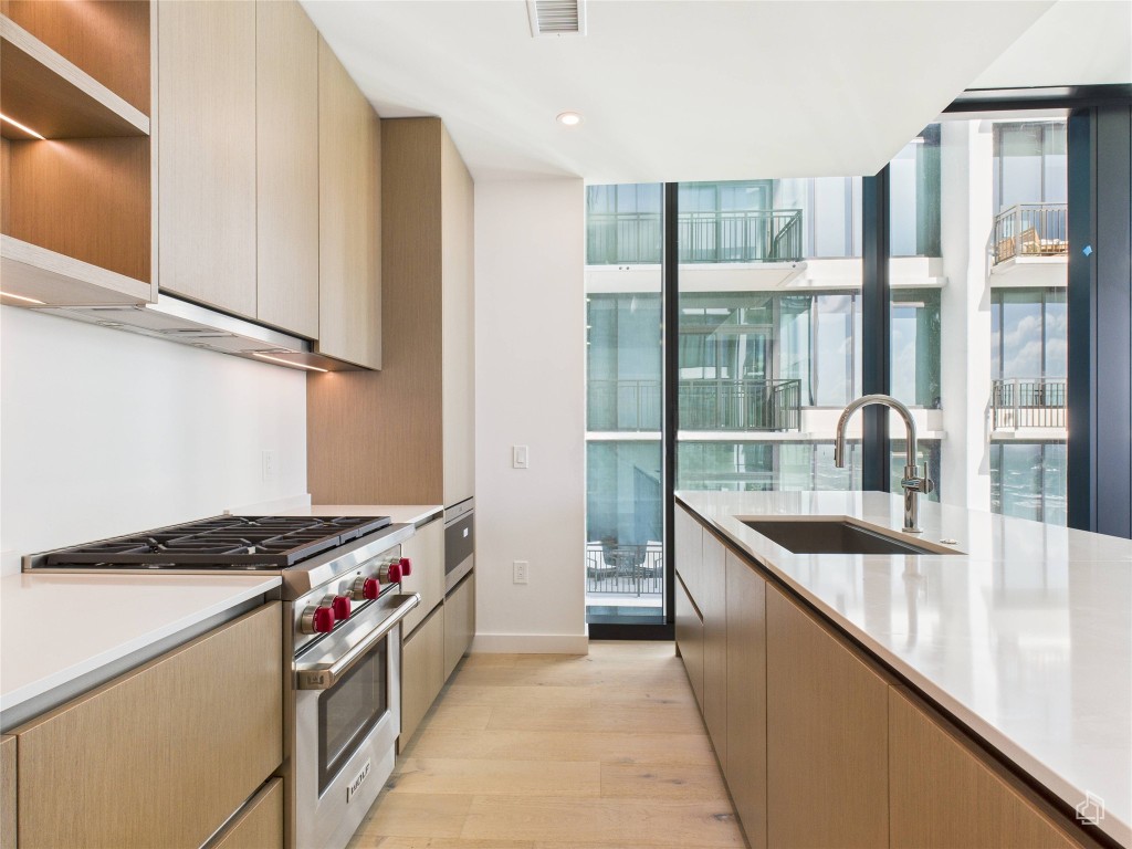 610 Davis Street, Unit 2808 Austin, TX 78701 - Photo 1 of 29 a kitchen with stainless steel appliances granite countertop a sink stove and refrigerator
