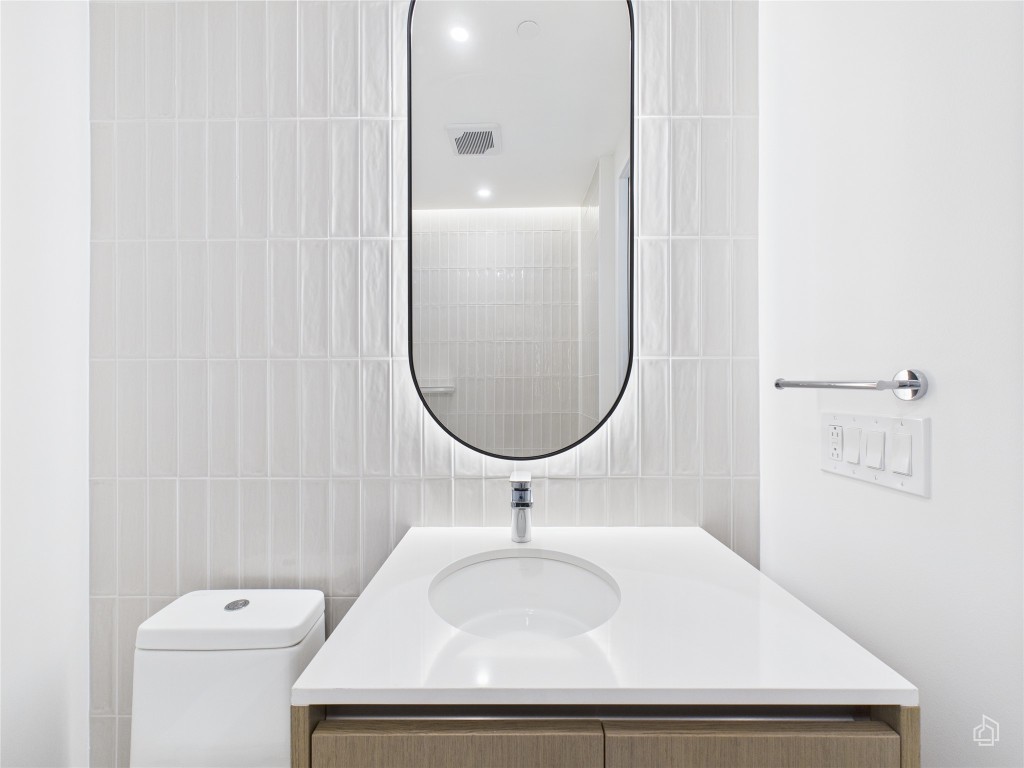 610 Davis Street, Unit 2808 Austin, TX 78701 - Photo 12 of 29 a bathroom with a sink a toilet and a mirror