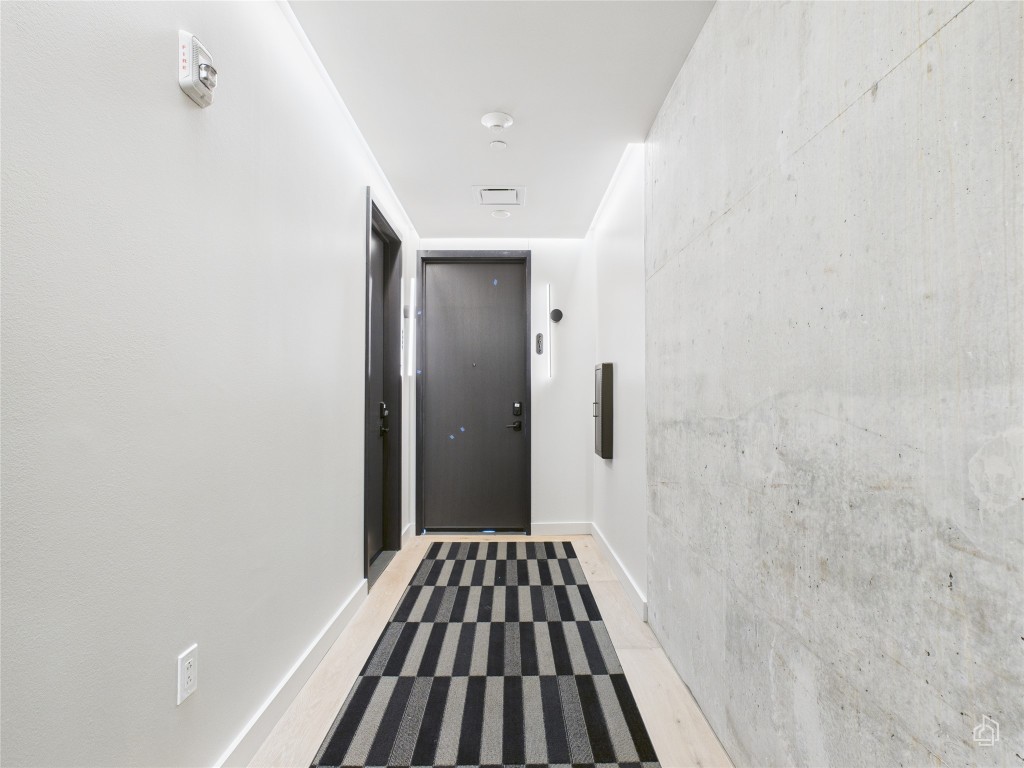 610 Davis Street, Unit 2808 Austin, TX 78701 - Photo 19 of 29 a view of a hallway view with wooden floor and staircase