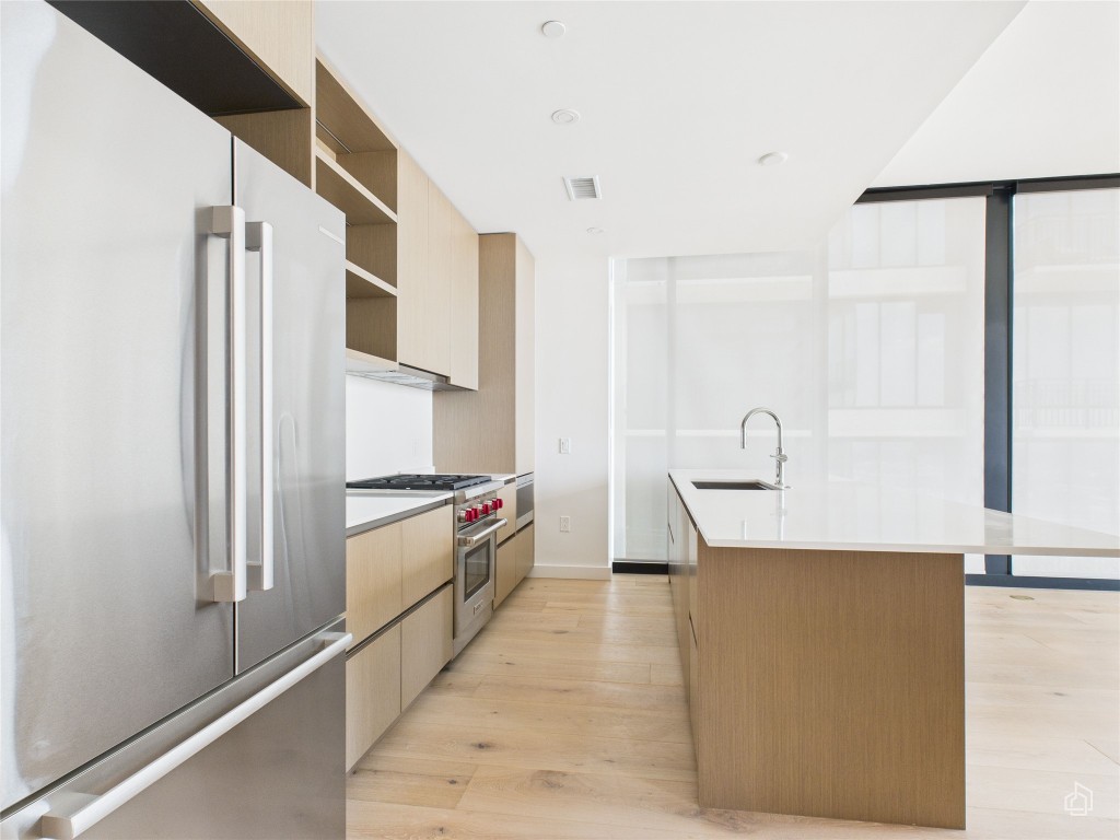 610 Davis Street, Unit 2808 Austin, TX 78701 - Photo 3 of 29 a kitchen with stainless steel appliances a refrigerator and a stove
