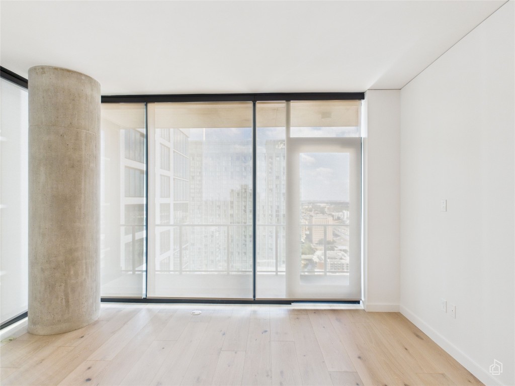 610 Davis Street, Unit 2808 Austin, TX 78701 - Photo 7 of 29 a view of an empty room with wooden floor and a window