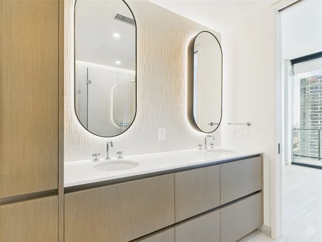 a bathroom with a double vanity sink and a mirror
