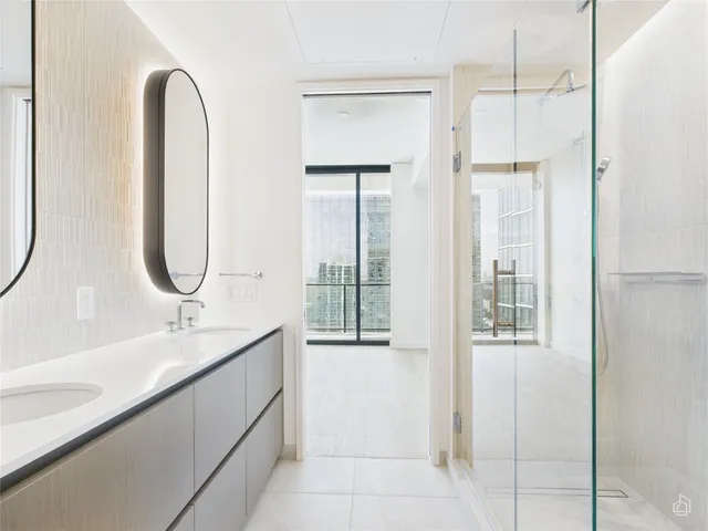 a bathroom with a double vanity sink and a mirror