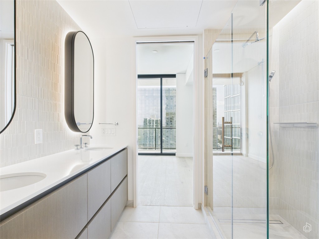 610 Davis Street, Unit 2808 Austin, TX 78701 - Photo 10 of 29 a bathroom with a double vanity sink and a mirror