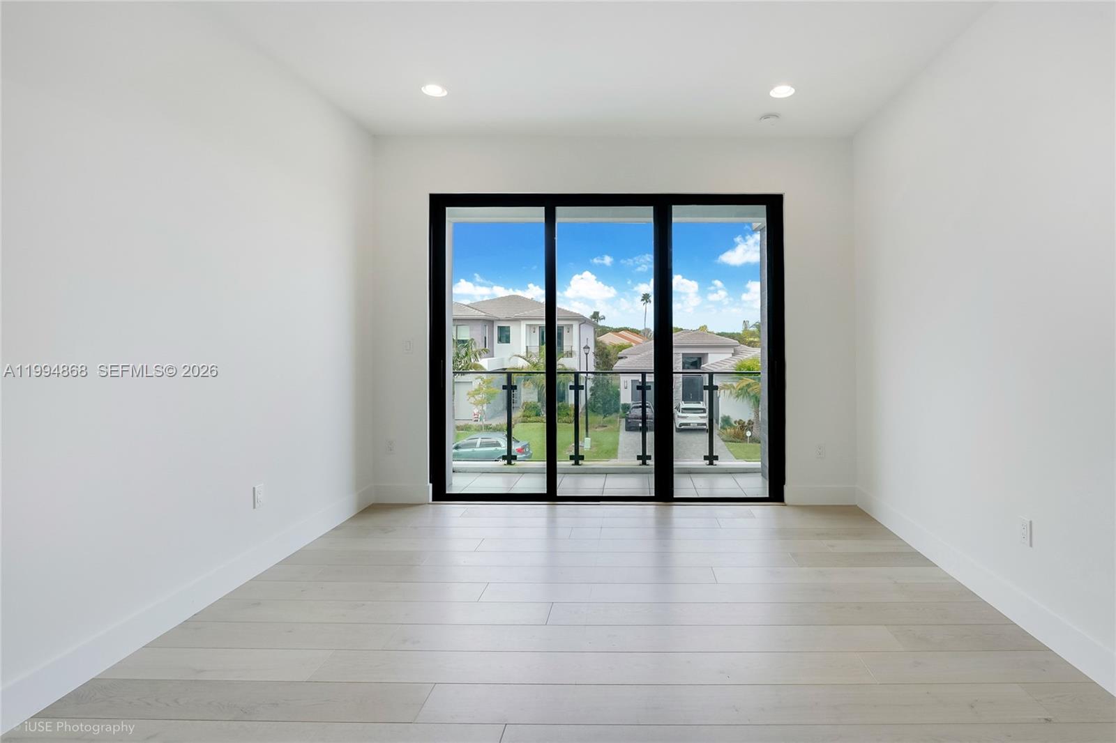 8095 Crystal Downs Avenue Boca Raton, FL 33434 - Photo 17 of 26 a view of an empty room with wooden floor and a window