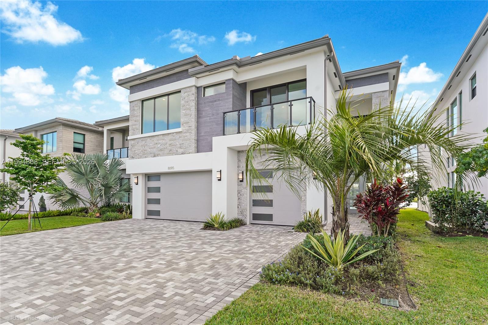 8095 Crystal Downs Avenue Boca Raton, FL 33434 - Photo 3 of 26 a front view of a house with a yard and a garage