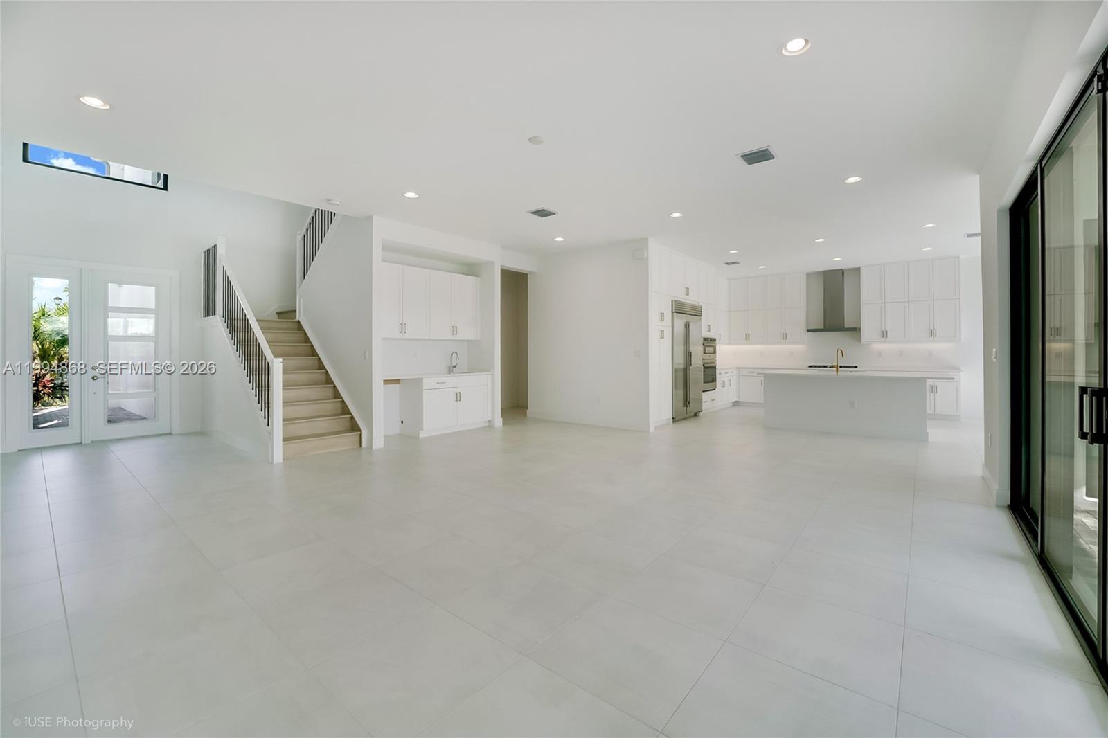 8095 Crystal Downs Avenue Boca Raton, FL 33434 - Photo 8 of 26 a view of a living room a kitchen with stainless steel appliances