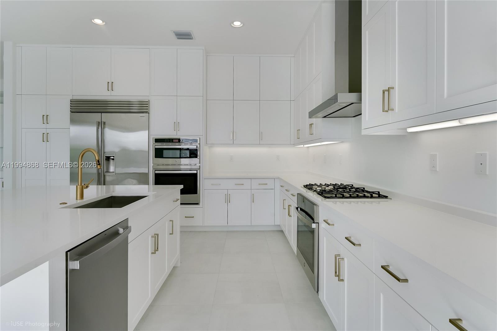 8095 Crystal Downs Avenue Boca Raton, FL 33434 - Photo 10 of 26 a kitchen with granite countertop white cabinets and white appliances
