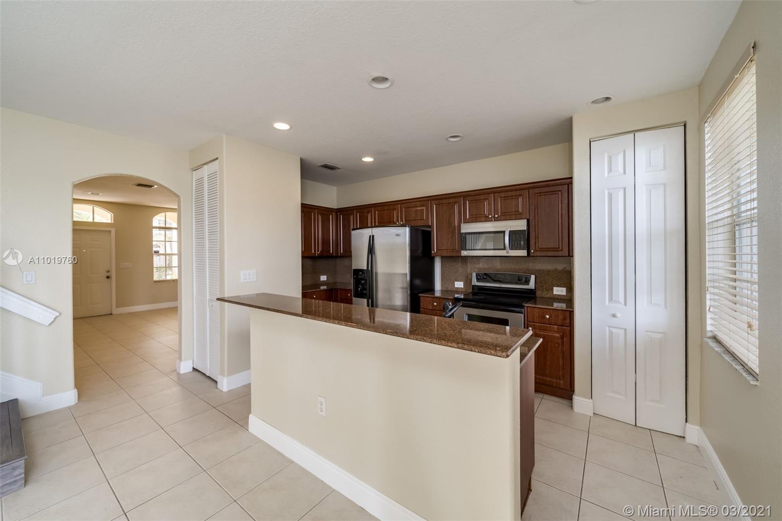 8437 Southwest 29th Street, Unit 102 Miramar, FL 33025 - Photo 13 of 29 a kitchen with stainless steel appliances granite countertop a refrigerator and a stove
