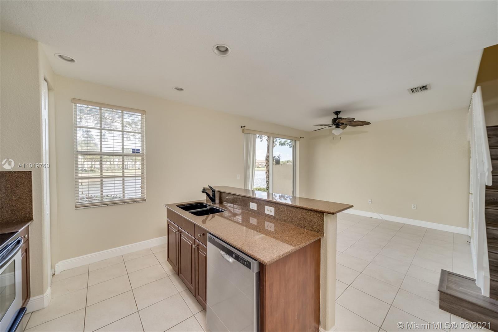 8437 Southwest 29th Street, Unit 102 Miramar, FL 33025 - Photo 14 of 29 a kitchen that has a sink a window and stainless steel appliances