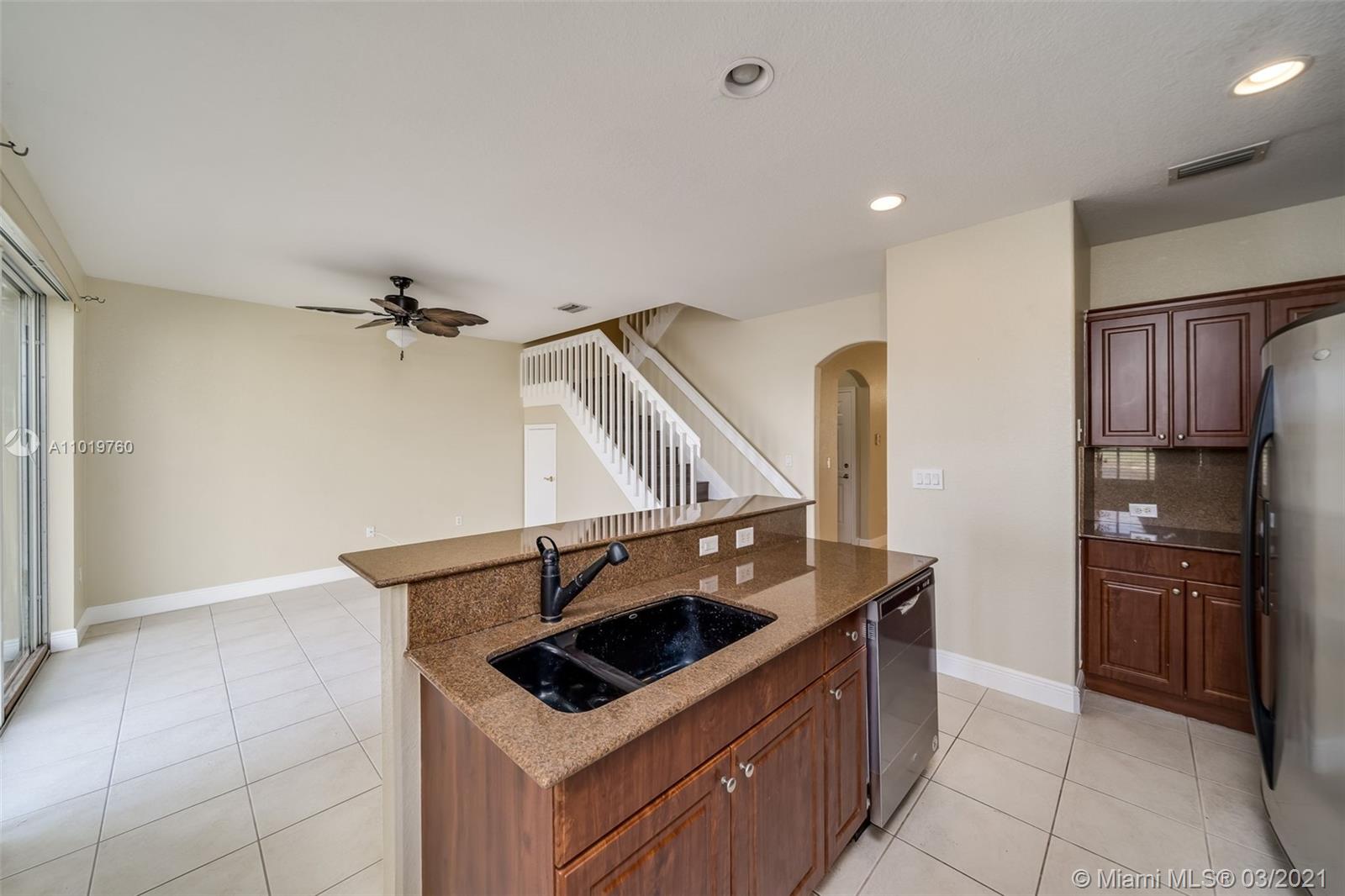8437 Southwest 29th Street, Unit 102 Miramar, FL 33025 - Photo 16 of 29 a kitchen that has a sink and a stove