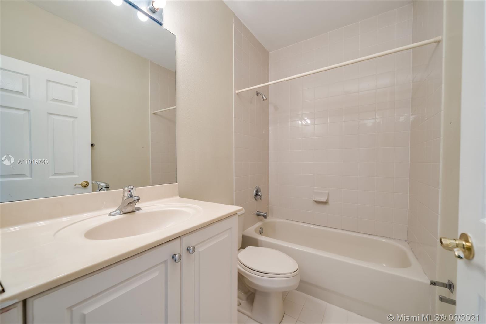 8437 Southwest 29th Street, Unit 102 Miramar, FL 33025 - Photo 17 of 29 a bathroom with a sink a toilet and shower