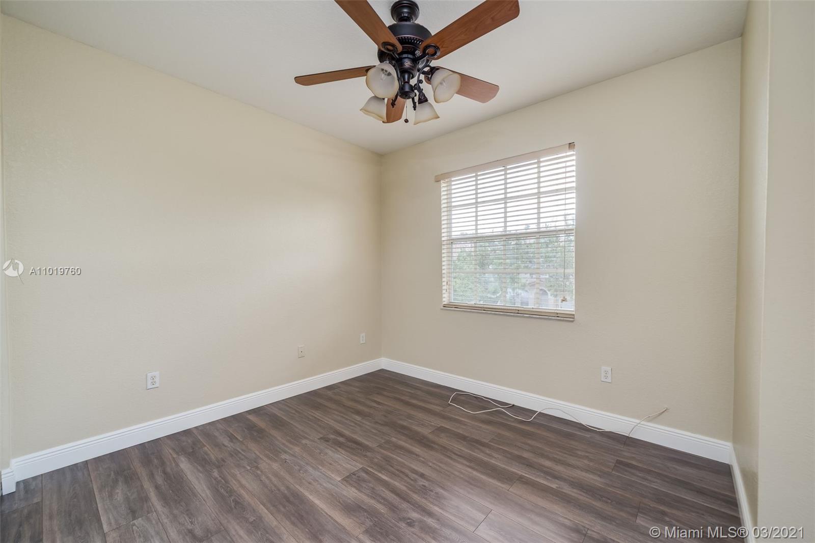 8437 Southwest 29th Street, Unit 102 Miramar, FL 33025 - Photo 18 of 29 wooden floor in an empty room with a window