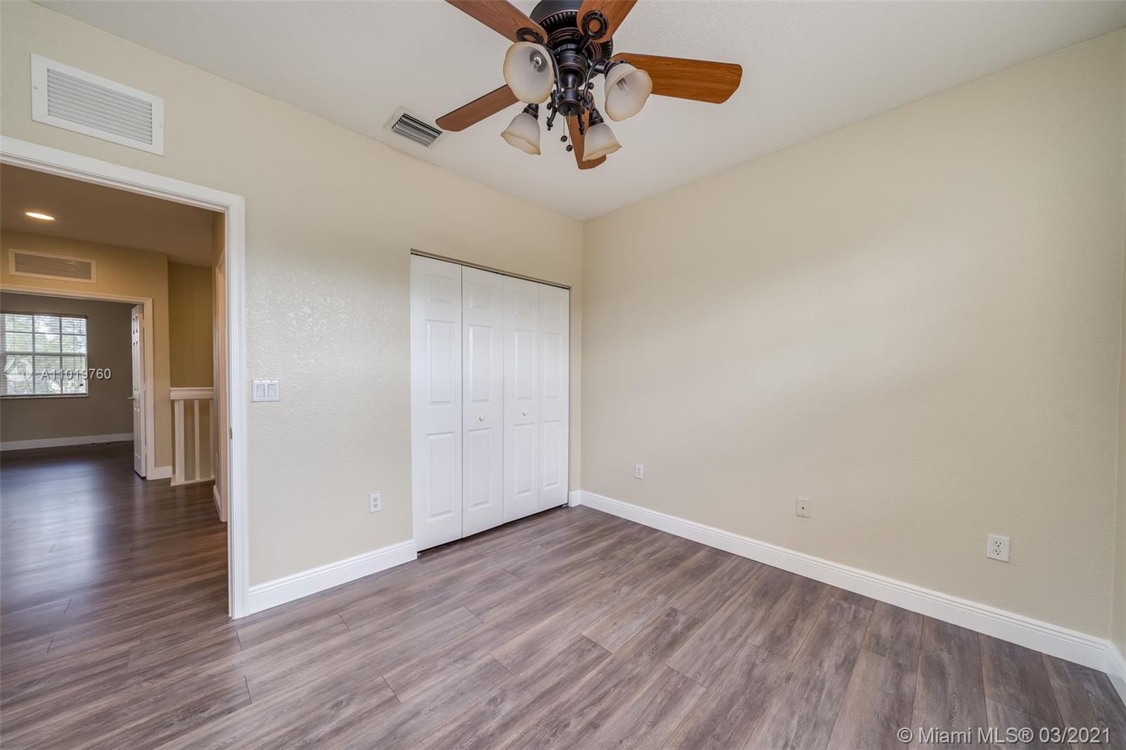 8437 Southwest 29th Street, Unit 102 Miramar, FL 33025 - Photo 19 of 29 a view of an empty room with window and wooden floor