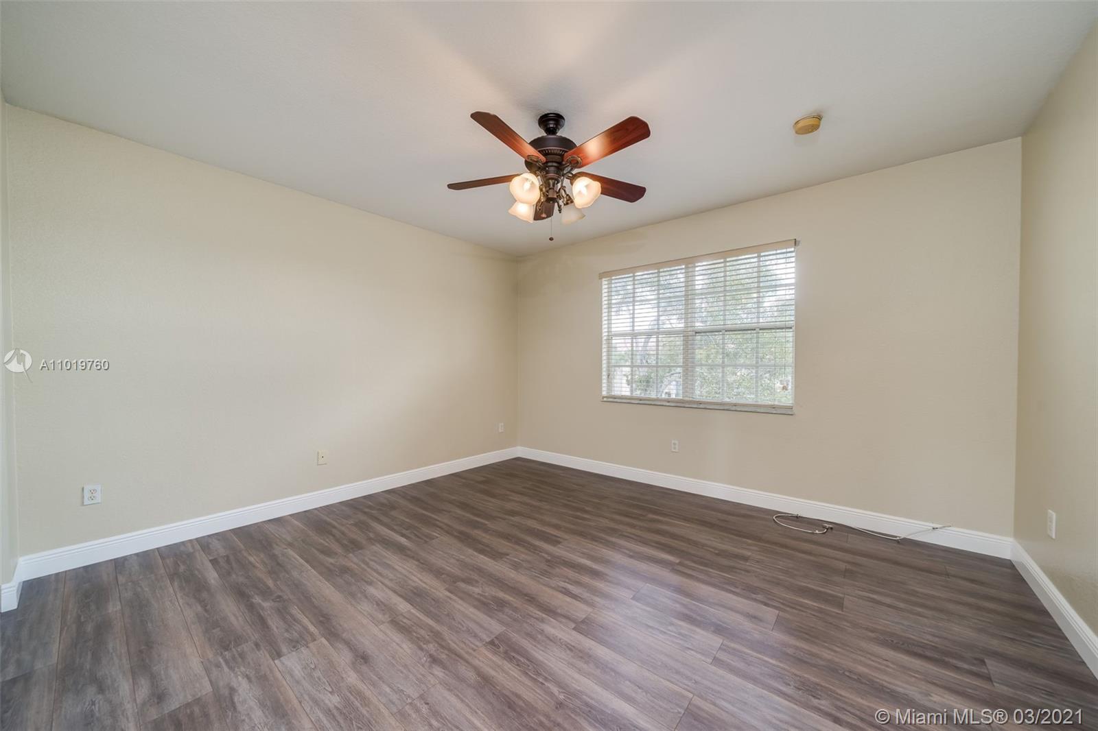 8437 Southwest 29th Street, Unit 102 Miramar, FL 33025 - Photo 21 of 29 wooden floor in an empty room with a window