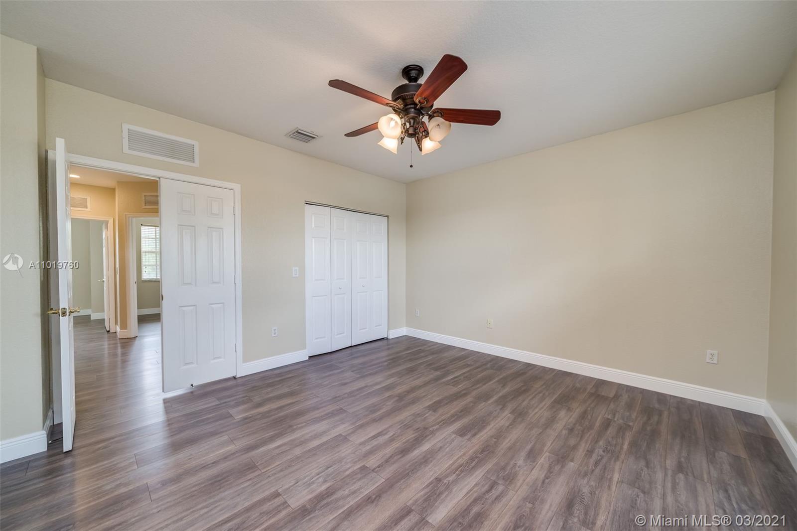 8437 Southwest 29th Street, Unit 102 Miramar, FL 33025 - Photo 22 of 29 a view of an empty room with wooden floor