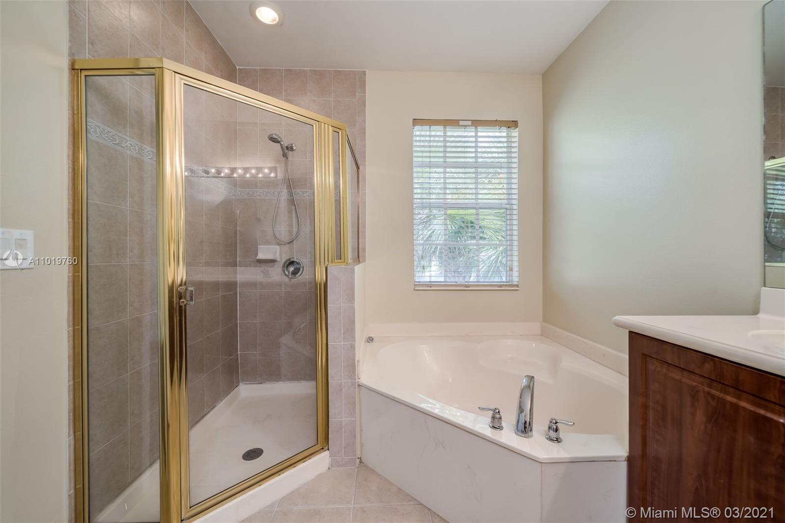 8437 Southwest 29th Street, Unit 102 Miramar, FL 33025 - Photo 25 of 29 a bathroom with a bathtub and a shower