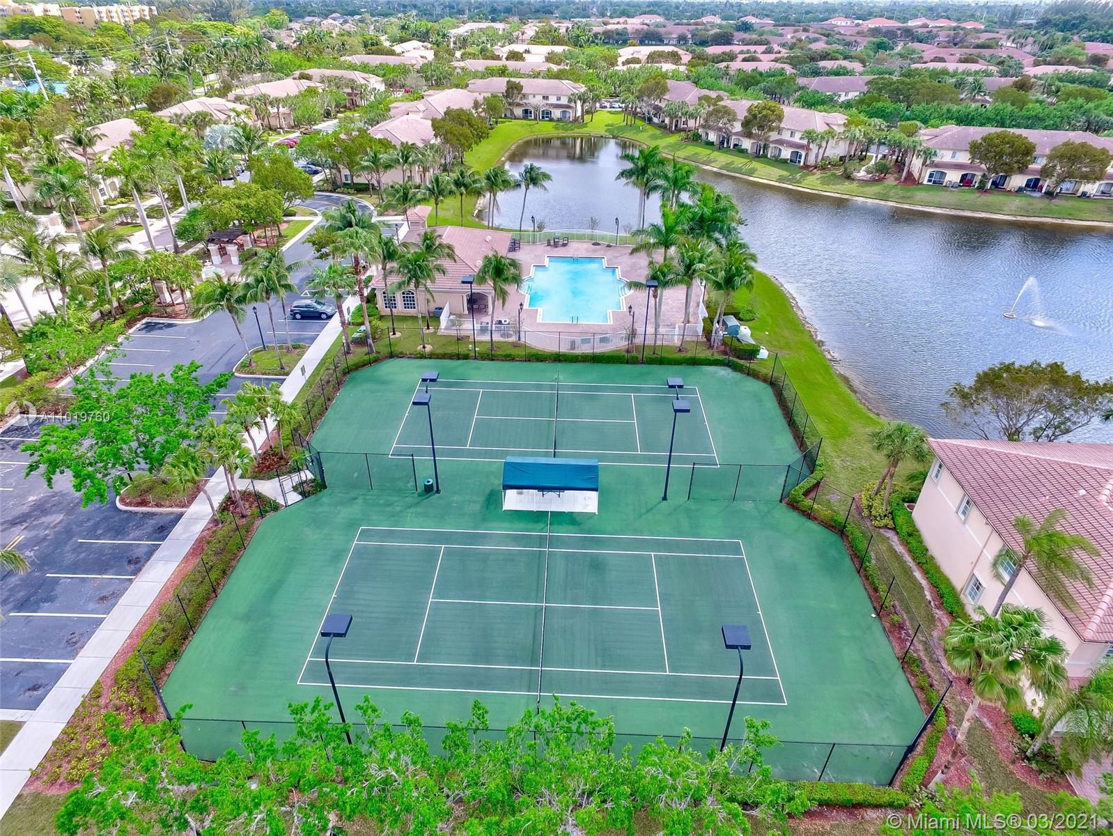 8437 Southwest 29th Street, Unit 102 Miramar, FL 33025 - Photo 29 of 29 an aerial view of a tennis ground with a swimming pool