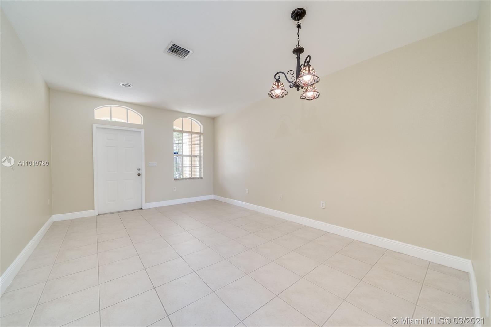 8437 Southwest 29th Street, Unit 102 Miramar, FL 33025 - Photo 6 of 29 wooden floor in an empty room with a window