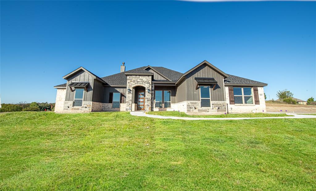 a front view of a house with a garden and yard