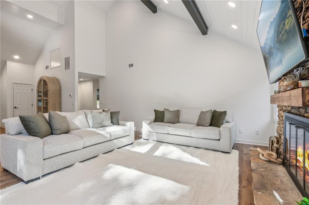 626 Petit Ridge Drive Big Canoe, GA 30143 - Photo 11 of 42 a living room with furniture a rug and a flat screen tv