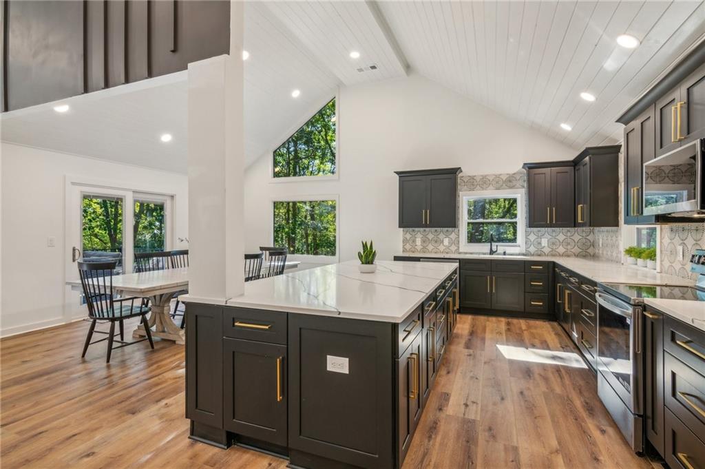 626 Petit Ridge Drive Big Canoe, GA 30143 - Photo 15 of 42 a kitchen with kitchen island granite countertop a sink a counter top space and stainless steel appliances