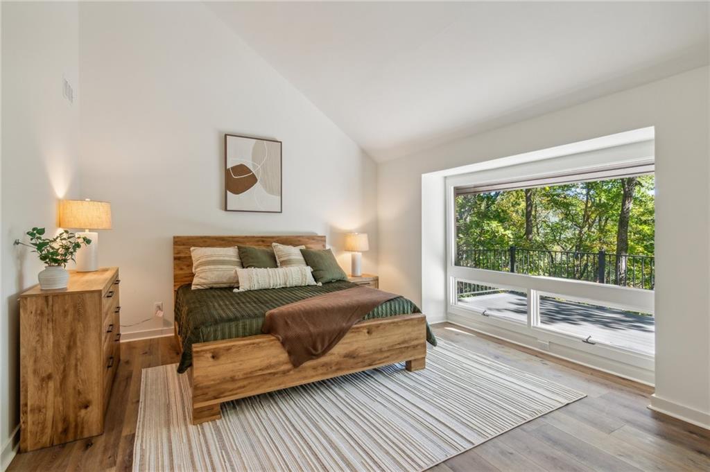 626 Petit Ridge Drive Big Canoe, GA 30143 - Photo 22 of 42 a bedroom with a bed and a large window