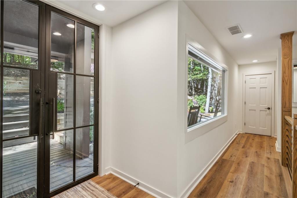 626 Petit Ridge Drive Big Canoe, GA 30143 - Photo 7 of 42 a view of hallway with a large window and wooden floor